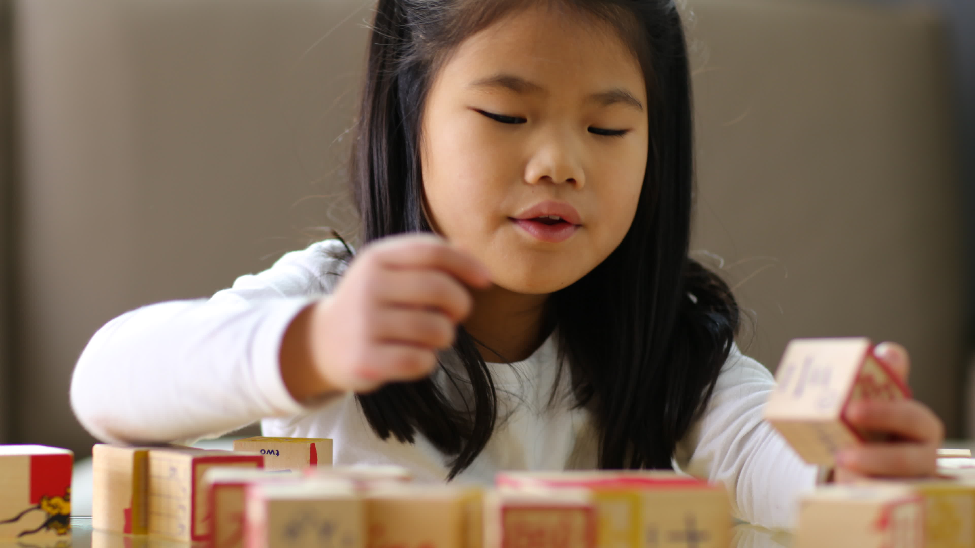 Young Asian girl stacking blocks 2568461 Stock Video at Vecteezy