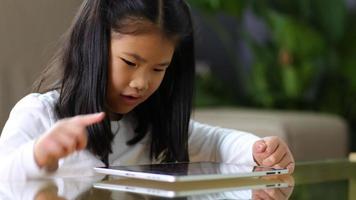 Young Asian girl using digital tablet video