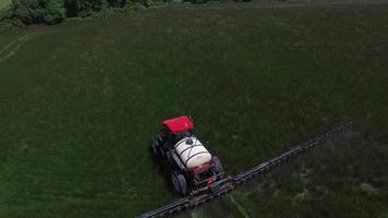 Aerial shot of tractor spraying grass seed farm video