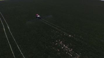 Aerial shot of tractor spraying grass seed farm video