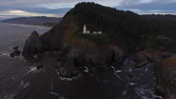 Aerial shot of Heceta Head Lighthouse at sunset, Oregon video