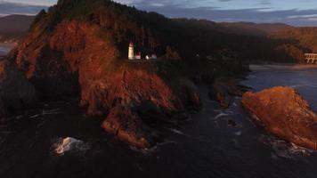 Aerial shot of Heceta Head Lighthouse at sunset, Oregon video