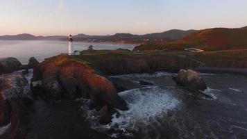 Aerial view of Yaquina Bay Lighthouse at sunset, Newport, Oregon video