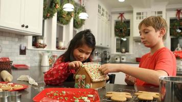 Decorating gingerbread house for Christmas video