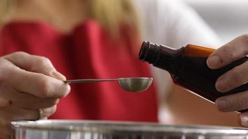 Measuring vanilla extract into mixing bowl video