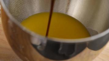 Pouring molasses into mixing bowl video