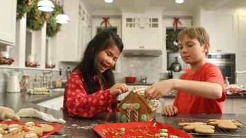 Decorating gingerbread house for Christmas video