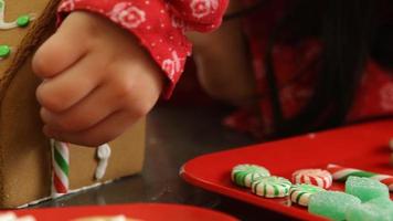 Decorating gingerbread house for Christmas video