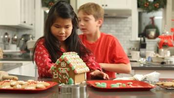 Decorating gingerbread house for Christmas video