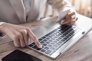 Online payment concept with young woman using computer laptop photo