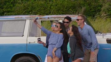 grupo de amigos na praia tirando selfie video