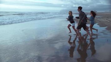 Super slow motion shot of group of friends running to beach, shot with Phantom Flex 4K video