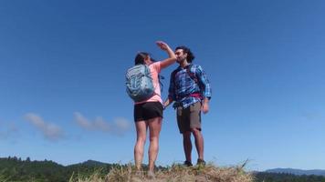 Hiking couple stop to take a look at view video