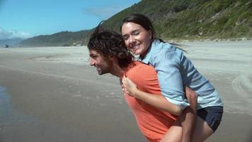 Couple at beach playing in super slow motion video