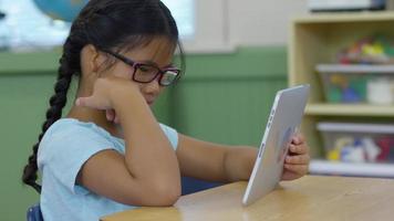 Student using digital tablet in school classroom