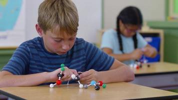Children in school classroom building science models