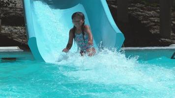 Girl going down waterslide in super slow motion video