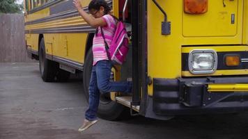 Students get off school bus, slow motion video