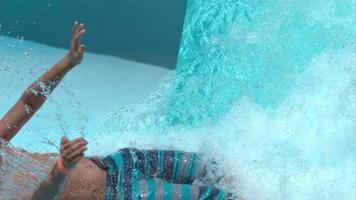 Boy going down waterslide in super slow motion video