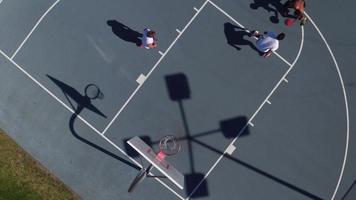 Friends playing basketball at park, overhead shot video
