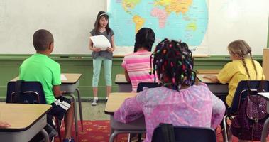 Student reading paper in front of class video