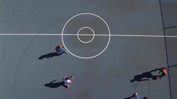 Friends playing basketball at park, overhead shot video