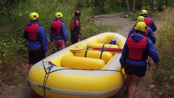 Group of people white water rafting carry raft together video