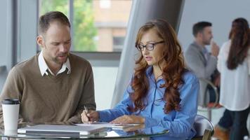 Two young business people meeting video