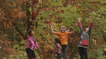 Group of kids in Fall throwing leaves video