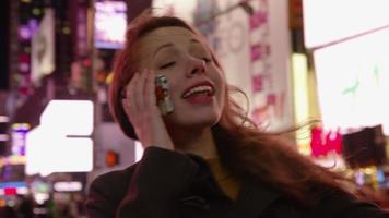 Woman talking on cell phone in Times Square, New York City