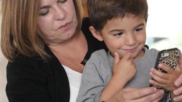 Mother and Son using smartphone together video