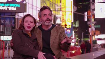 Couple sitting together talking in Times Square, New York City video