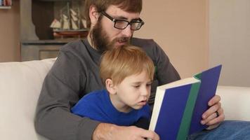 Father and Son reading a book together video