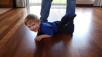 Father and Son at home tickling and playing video