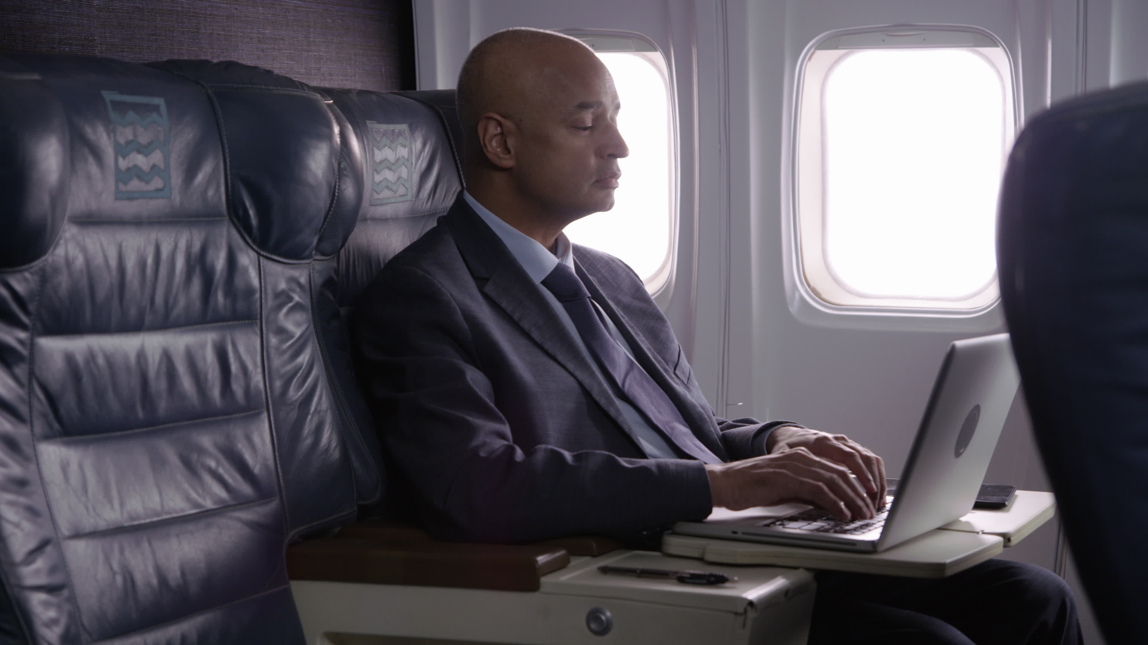 Businessman using laptop computer on airplane 2571004 Stock Video at