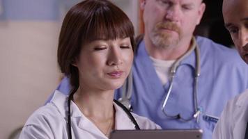 Closeup of medical professionals looking at digital tablet together