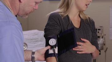 Pregnant woman has blood pressure taken