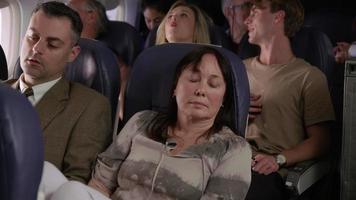 Woman trying to sleep on airplane flight video