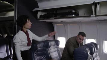 Flight attendant helps passengers board airplane video