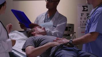 Emergency room doctors examine man with head injury