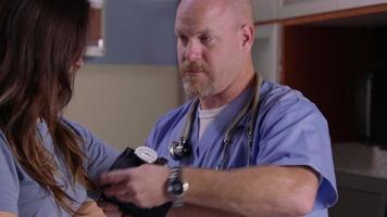 Male nurse check patient's blood pressure video