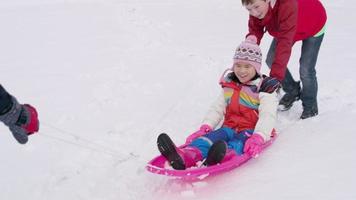 Kids playing and pushing sled in winter snow video