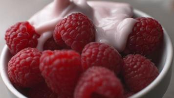 Yogurt pouring onto fresh raspberries in super slow motion, shot on Phantom Flex 4K