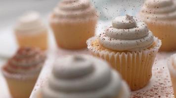 Cinnamon sprinkled onto vanilla cupcakes in super slow motion, shot on Phantom Flex 4K video