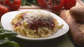 Parmesan cheese sprinkled onto pasta in super slow motion, shot on Phantom Flex 4K video