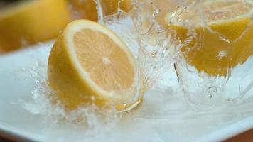 Lemon halves falling into water in super slow motion, shot with Phantom Flex 4K video