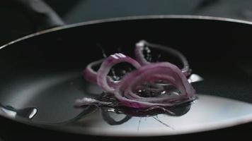 Red onion into pan with oil in super slow motion, shot on Phantom Flex 4K video