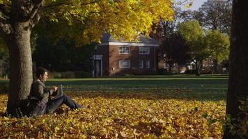 College student on campus using laptop computer video