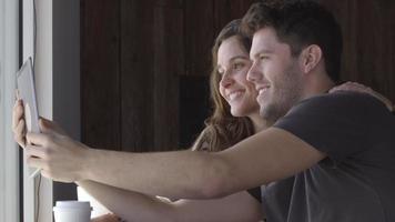 Young woman and man talking selfie together in cafe video