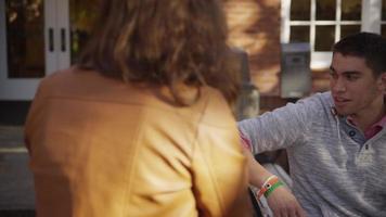 College students on campus meet in courtyard video